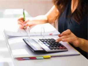 a woman calculating finance on calculator